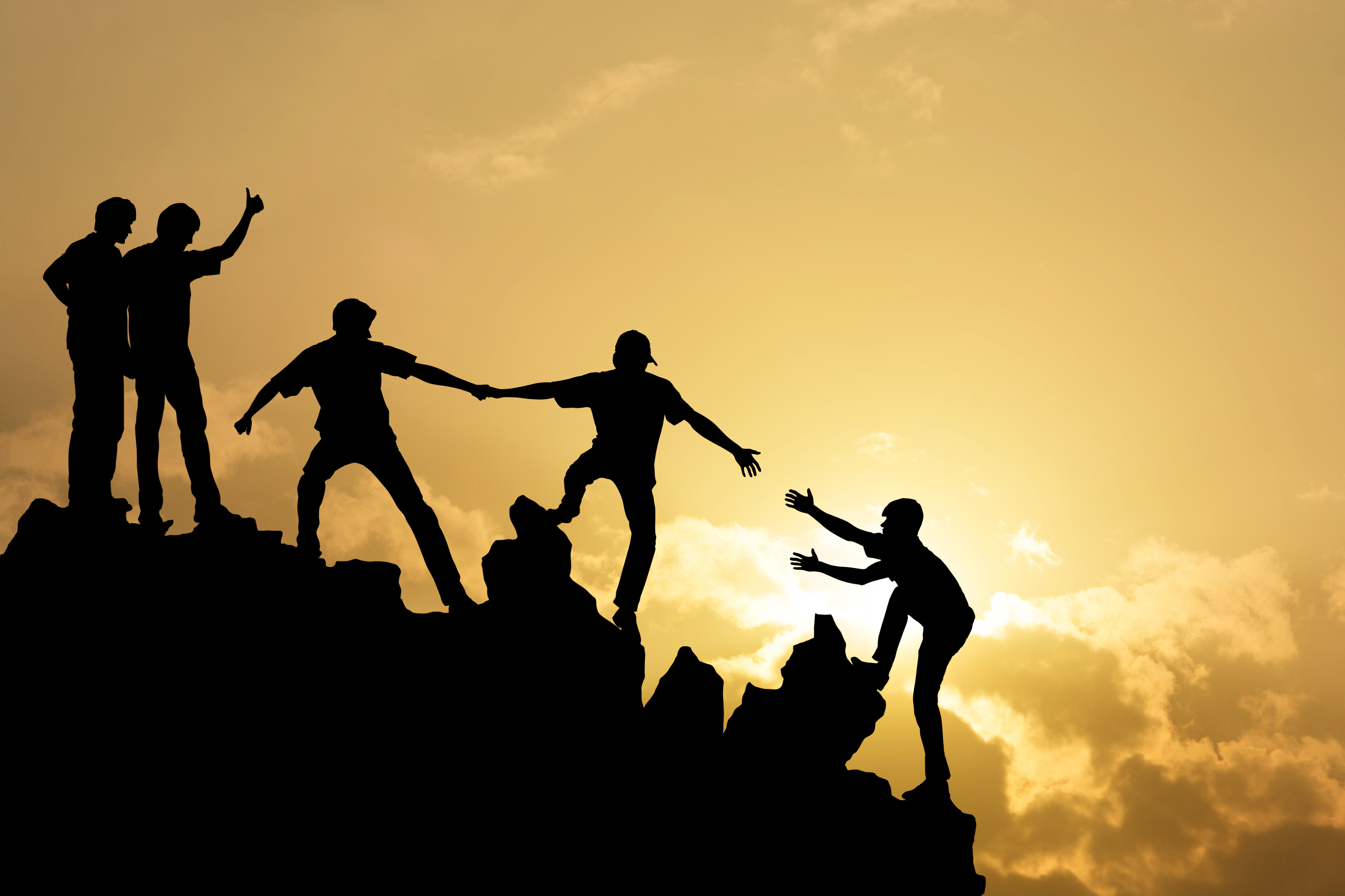 Climbers helping each other reach the summit — support and engagement over the long term