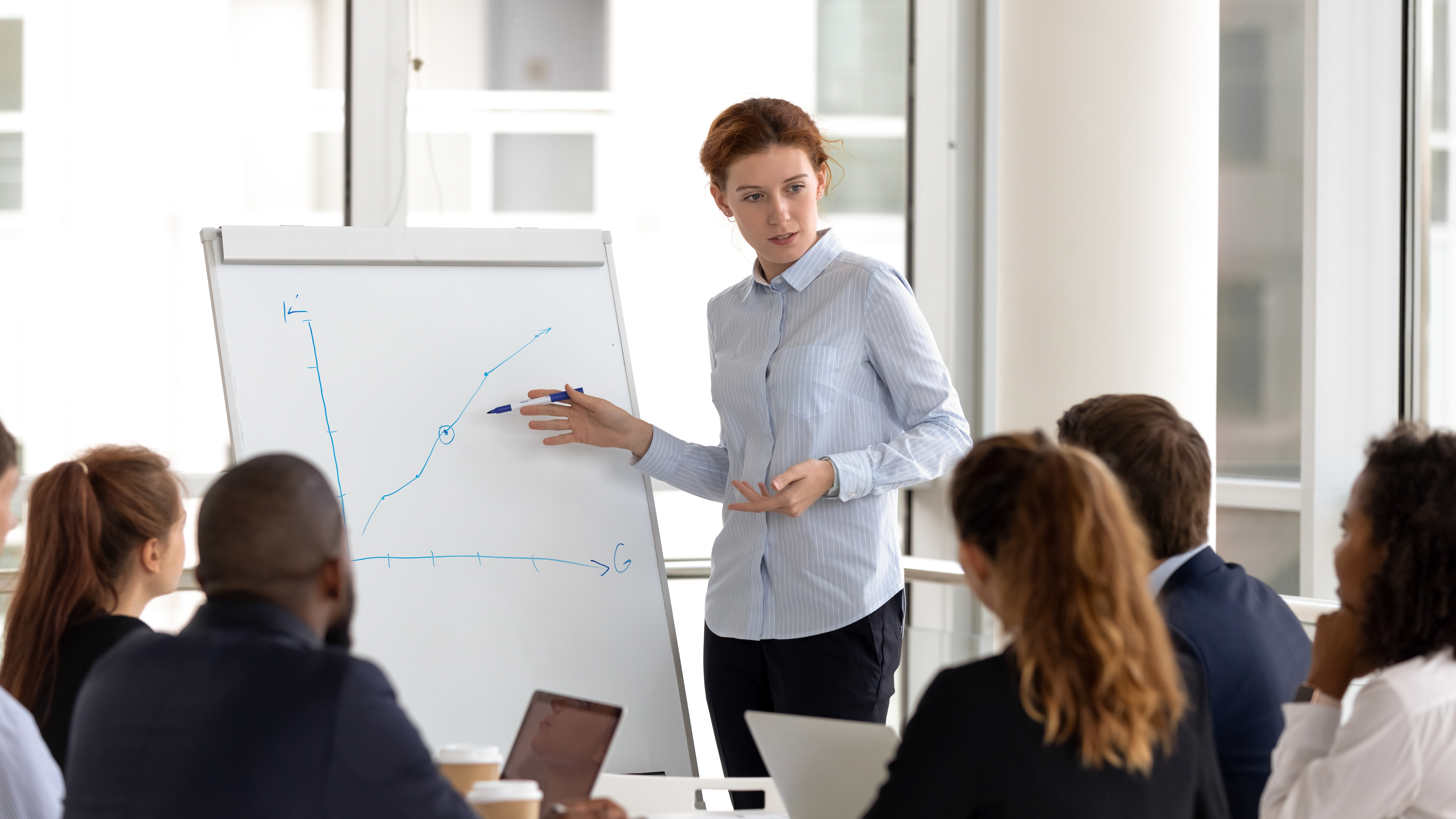 Facilitator presenting a growth chart at a flip chart — candidate photo for Colibrí Learn